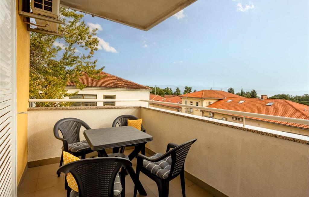 a patio with chairs and a table on a balcony at 2 Bedroom Lovely Apartment In Lovran in Lovran