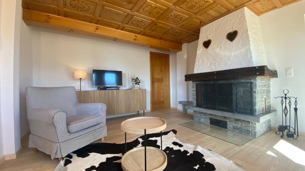 a living room with a chair and a fireplace at am Bärgbach 1.OG in Bettmeralp