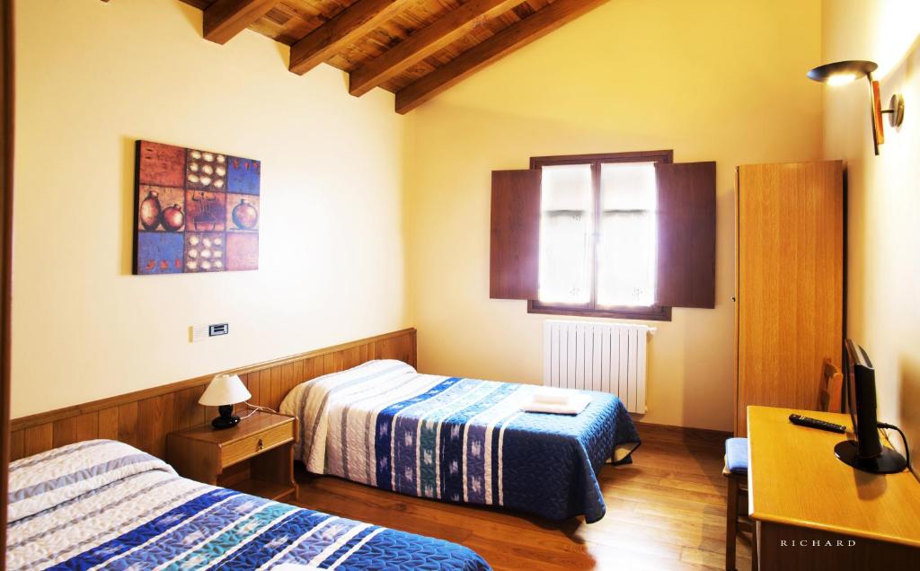 Postel nebo postele na pokoji v ubytování Hostal Musunzar