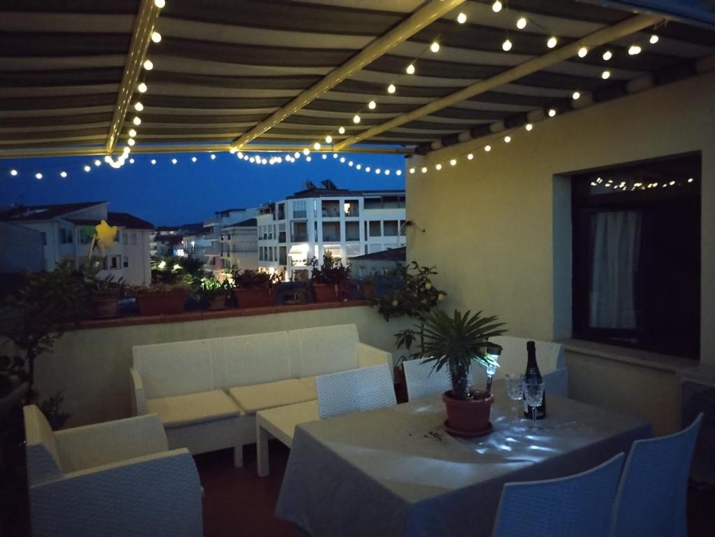 a patio with a table and chairs and lights at Terraced paradise in Alghero