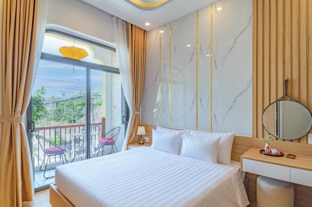 Postel nebo postele na pokoji v ubytování Mint Hoi An Villa