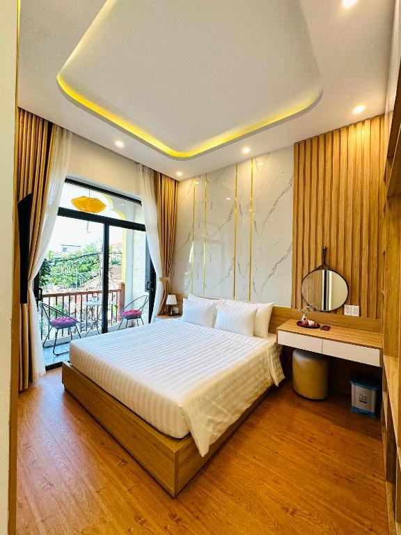 Postel nebo postele na pokoji v ubytování Mint Hoi An Villa