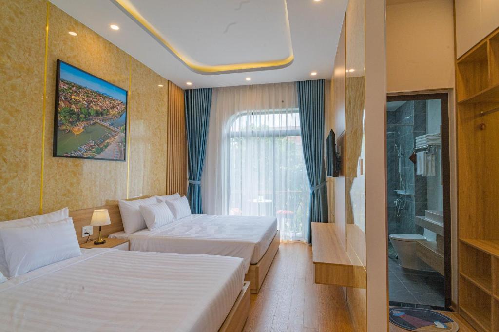 Postel nebo postele na pokoji v ubytování Mint Hoi An Villa