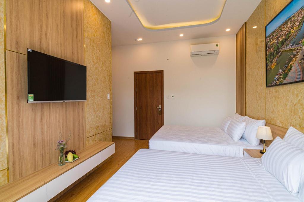Postel nebo postele na pokoji v ubytování Mint Hoi An Villa