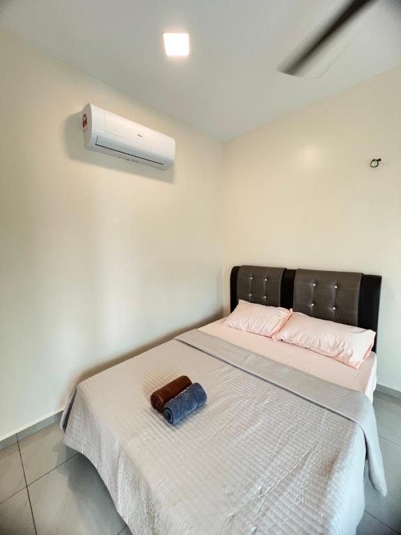 a bedroom with a bed with a air conditioner on it at AA SWEET ROOM TANJUNG BIDARA MELAKA in Masjid Tanah