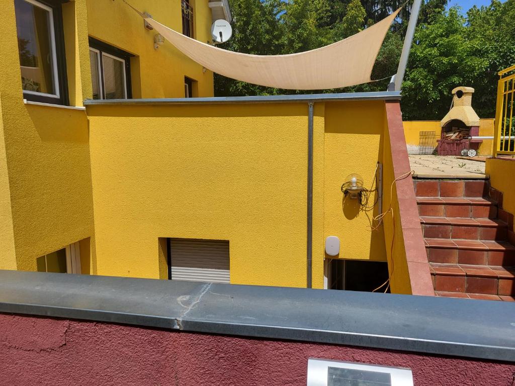 a yellow building with a hammock on top of it at EXPLORE Wien Österreich VIENNA Austria WALTZ and CASTLES Residenz Habsburg great 2-rooms-apartment near SCHÖNBRUNN Breakfast Metro U3 U4 busses 48a 51a city kids pets in Vienna
