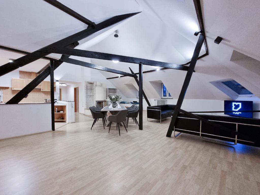 a large living room with a table and chairs at Alpha Apartments in Krefeld