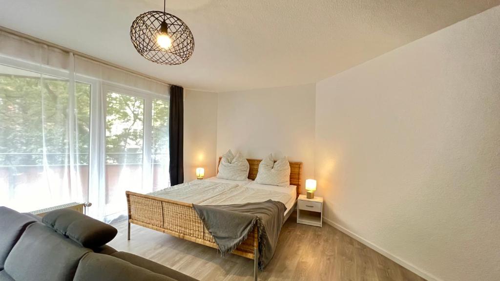- une chambre avec un lit et un canapé dans l'établissement Wohnung in Linden - Stadtleben - 68qm, Küche, Bad, 2 Balkons, 5 Personen, WIFI, à Hanovre
