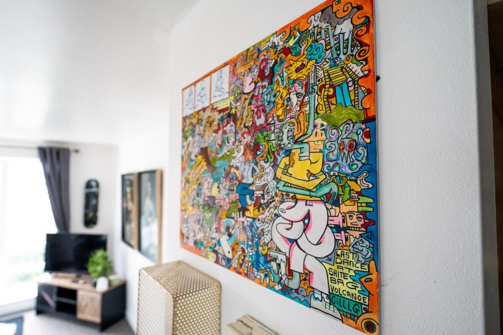 a large painting hanging on a wall in a living room at Artistic stunning apartment city view in Clooney Park