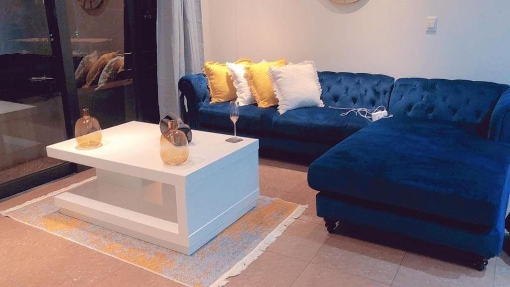 a living room with a blue couch and a table at Marble nights in Johannesburg