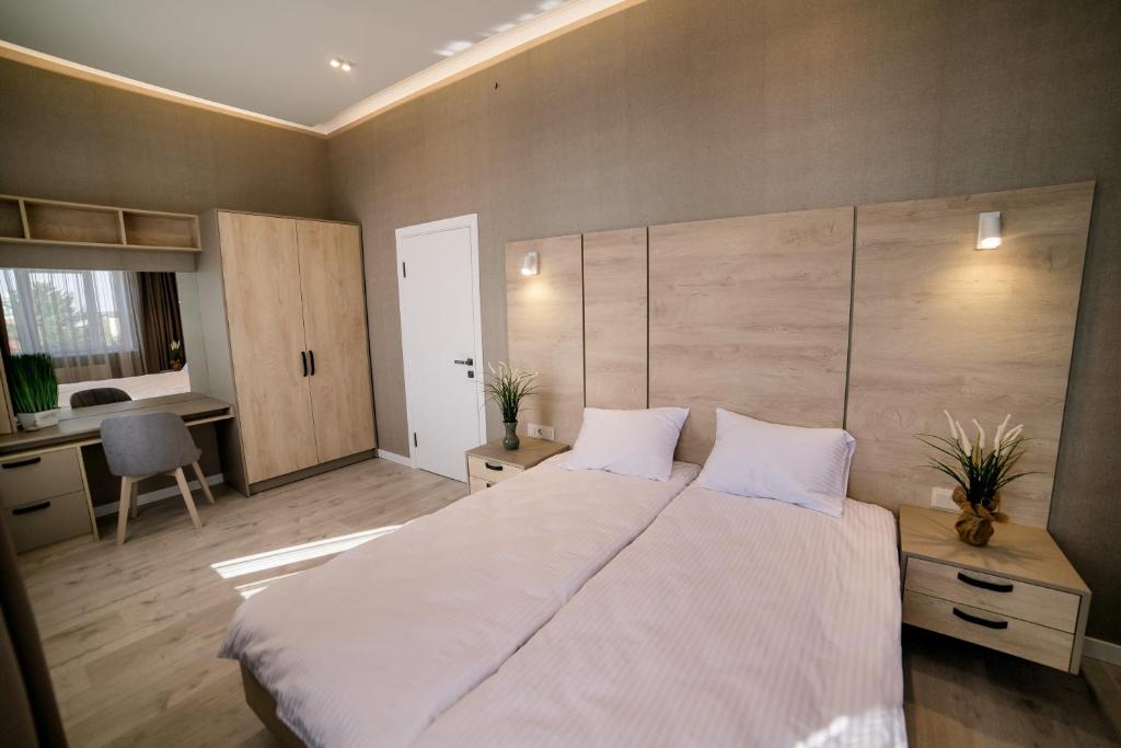 Postel nebo postele na pokoji v ubytování Apart-Hotel CARDINAL
