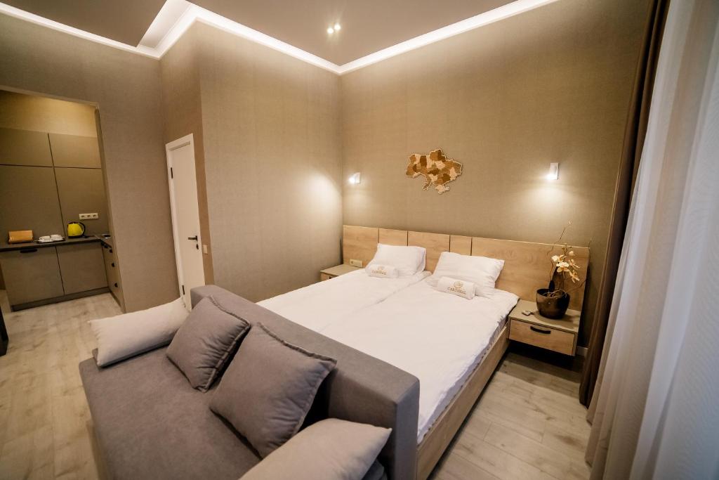 Postel nebo postele na pokoji v ubytování Apart-Hotel CARDINAL