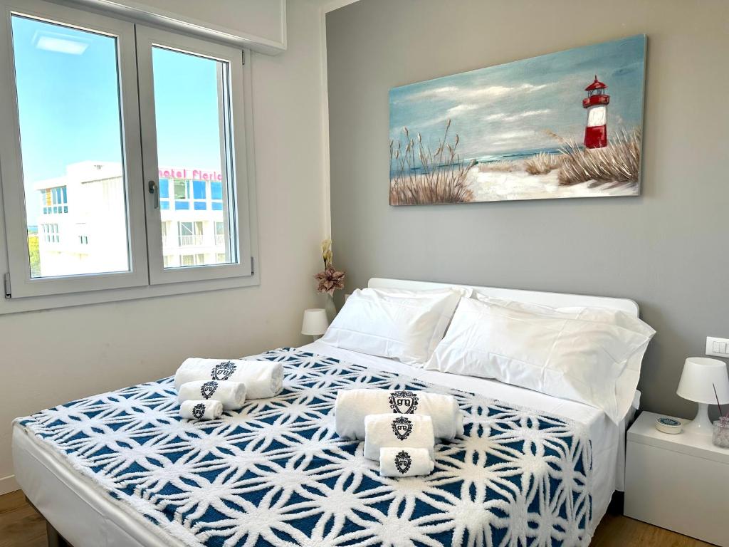 a bedroom with a bed with two pillows on it at Beach Front Apartment Sabbiadoro in Lignano Sabbiadoro