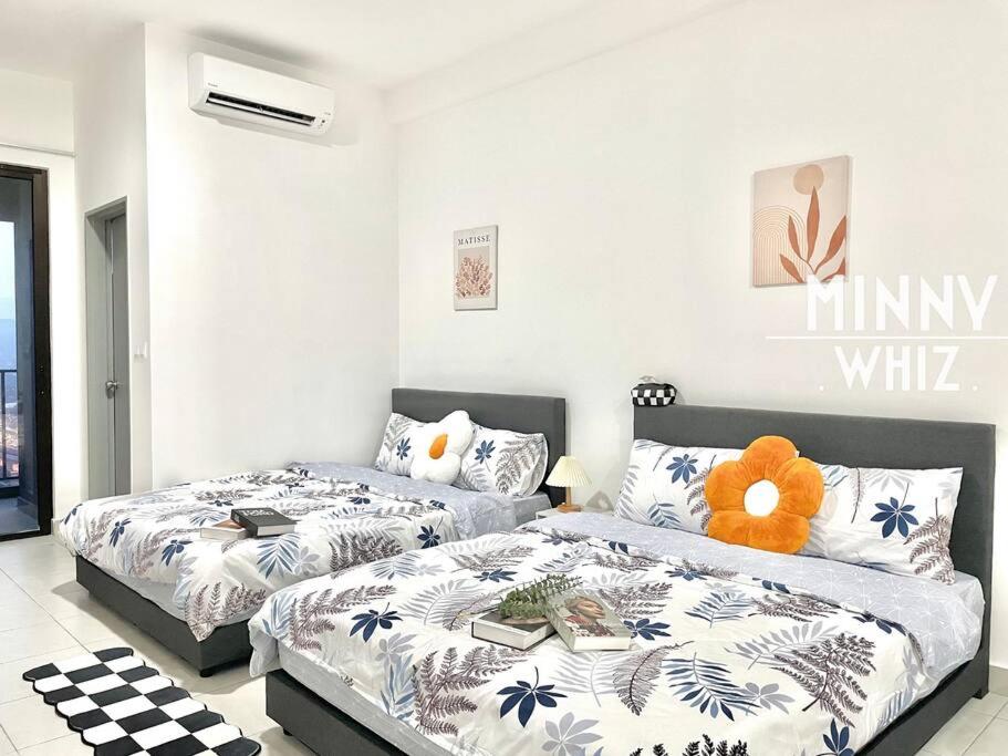 a bedroom with two beds and a teddy bear at Netizen Balcony View MRT 4-5pax #17 in Cheras