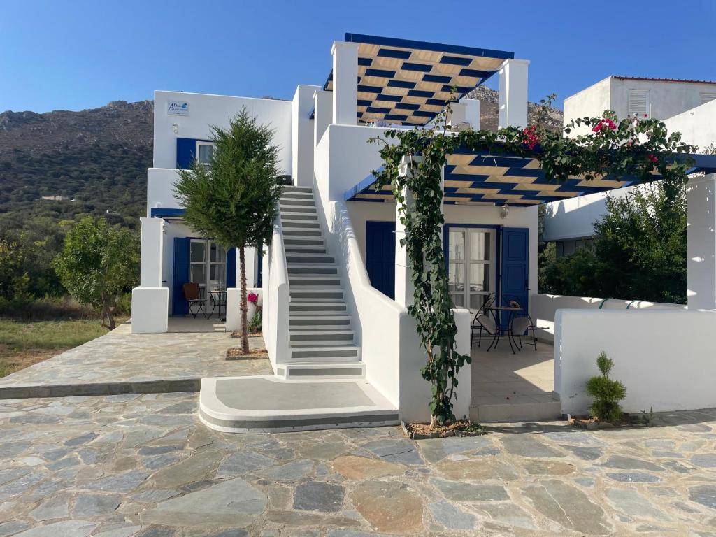 a white house with stairs and flowers on it at Deda Apartments in Livadia