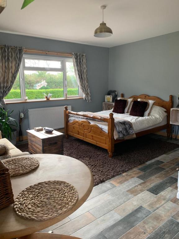 a bedroom with two beds and a table at Wild winds Annex in New Quay