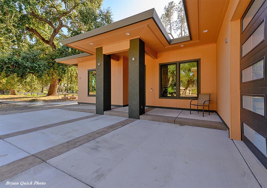 a house with a window and a chair in front of it at Three Bedroom River Access in Redding