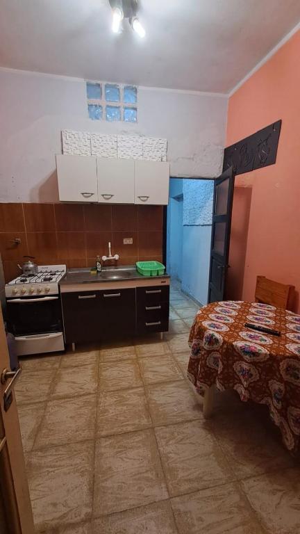 a kitchen with a sink and a stove at Alquiler por día- Zona Centro in San Fernando del Valle de Catamarca