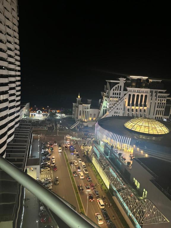 a view of a busy city street at night at Orbi Plaza Tamara in Batumi