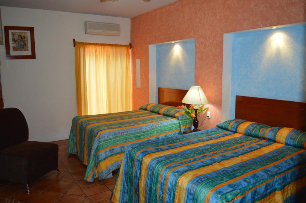 Postel nebo postele na pokoji v ubytování Hotel La Rienda Mision Tequillan