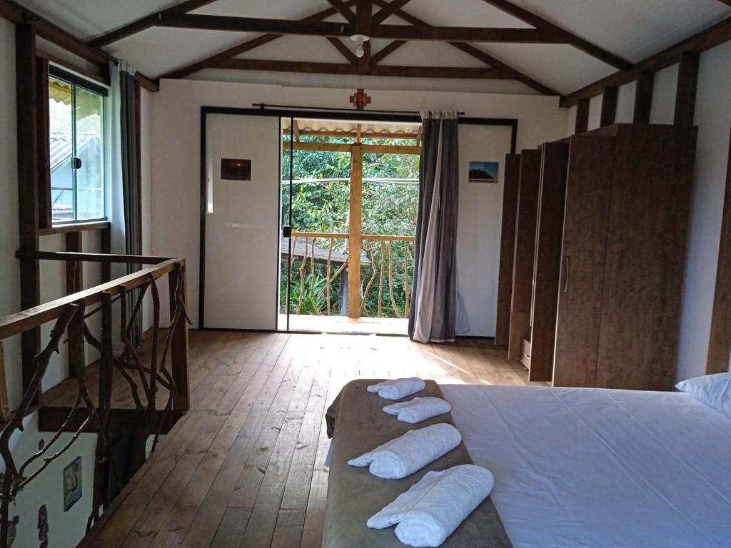 a bedroom with a bed with rolled towels on it at Chalé Encantadas Eco Ilha Preserve in Ilha do Mel