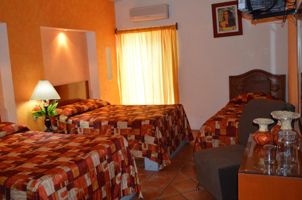 Postel nebo postele na pokoji v ubytování Hotel La Rienda Mision Tequillan