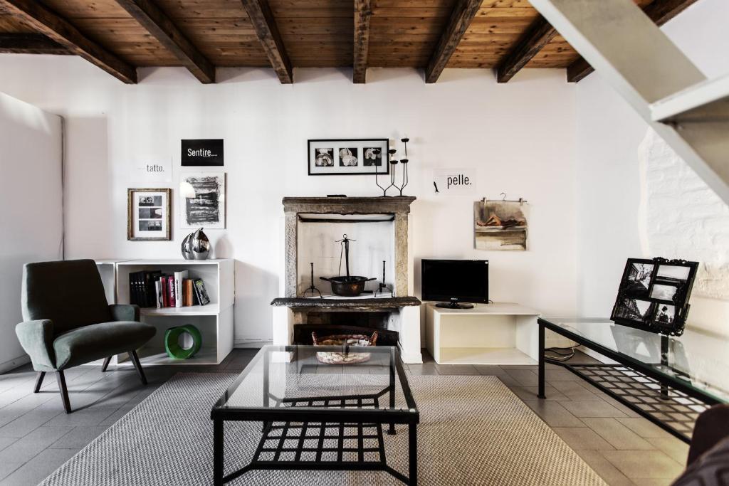 ein Wohnzimmer mit einem Tisch und einem Kamin in der Unterkunft MilanRentals - Ripa Apartment in Mailand