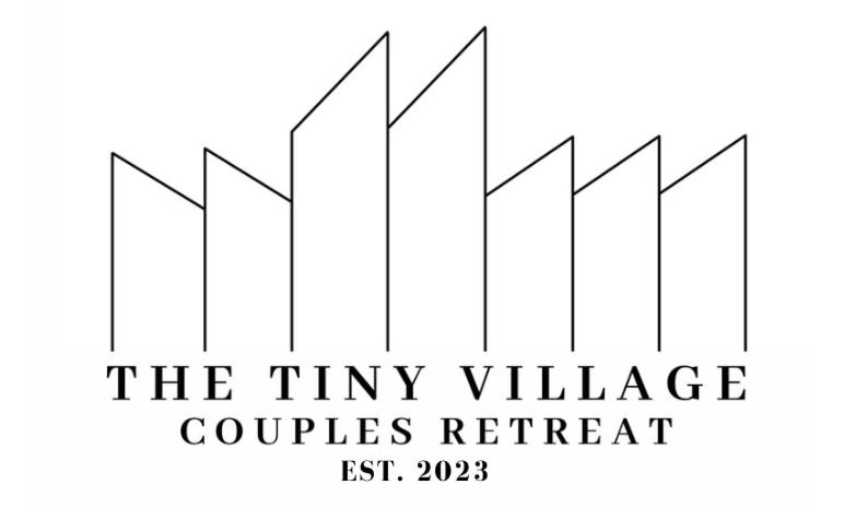 a black and white logo for the tiny village campuses retreat at The Tiny Village Couple Retreat in Cabo Rojo