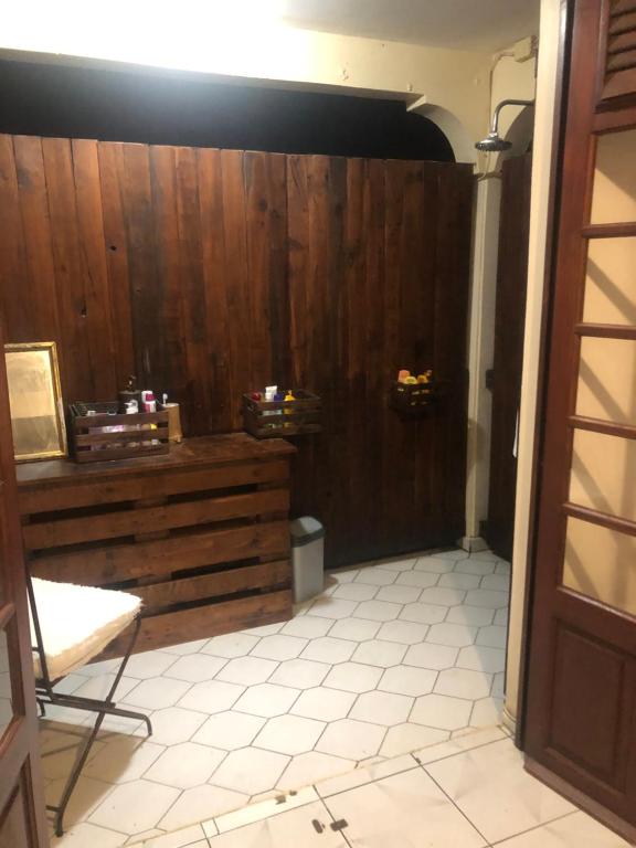 a room with a wooden wall and a table at Chambre d'hôtes MAÏ TAÏ 4 personnes Bas du Fort in Le Gosier