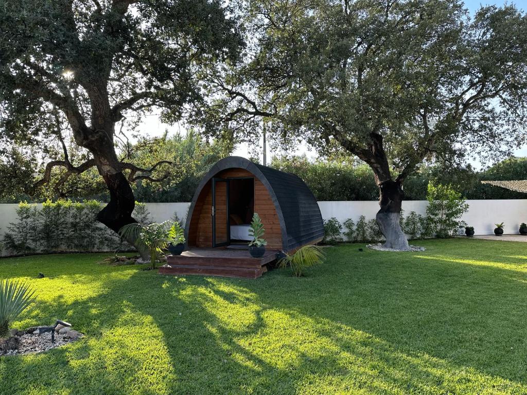 a small tent in a yard with a tree at Bungalow Madeira - Casa das Lages - Almancil - Quinta do Lago in Almancil