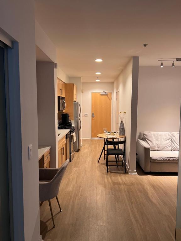 a living room and a kitchen with a bed and a table at Cozy Santa Monica getaway steps to the beach Free Parking in Los Angeles