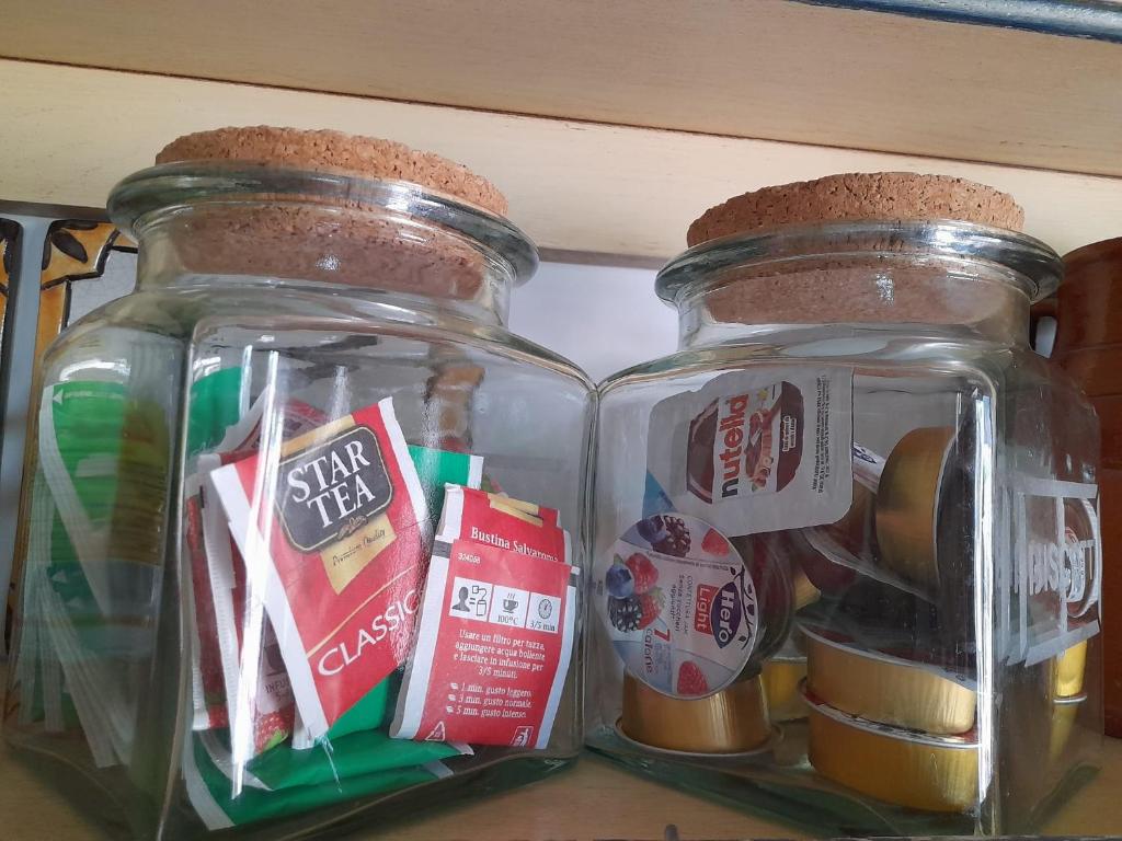 two glass jars sitting on top of a shelf at Villa Rossi in Polignano a Mare