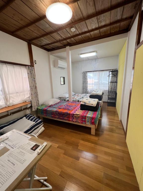 a room with a bed and a table in it at Japanese Onlyの古民家-Villa Ukishima- in Naha
