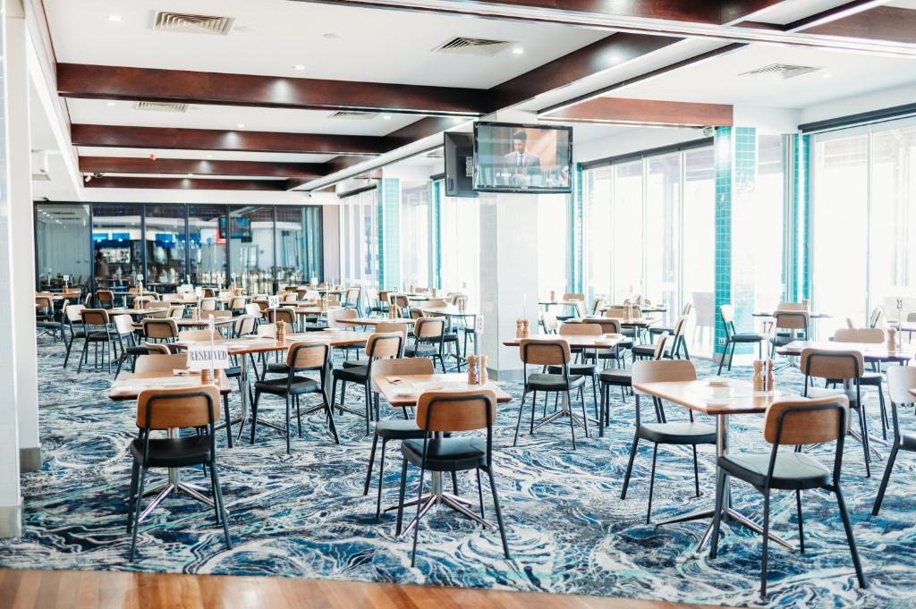 a dining room filled with tables and chairs at Ceduna Foreshore Hotel Motel in Ceduna