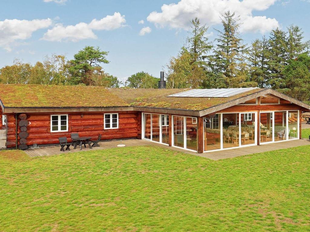 a log cabin with a large yard in front of it at 24 person holiday home in Læsø-By Traum in Læsø
