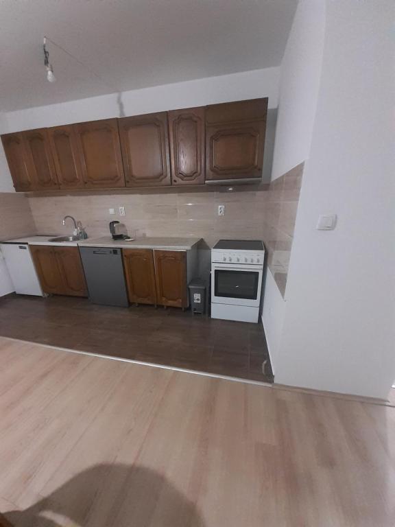 an empty kitchen with wooden cabinets and a stove at Dunav in Smederevo