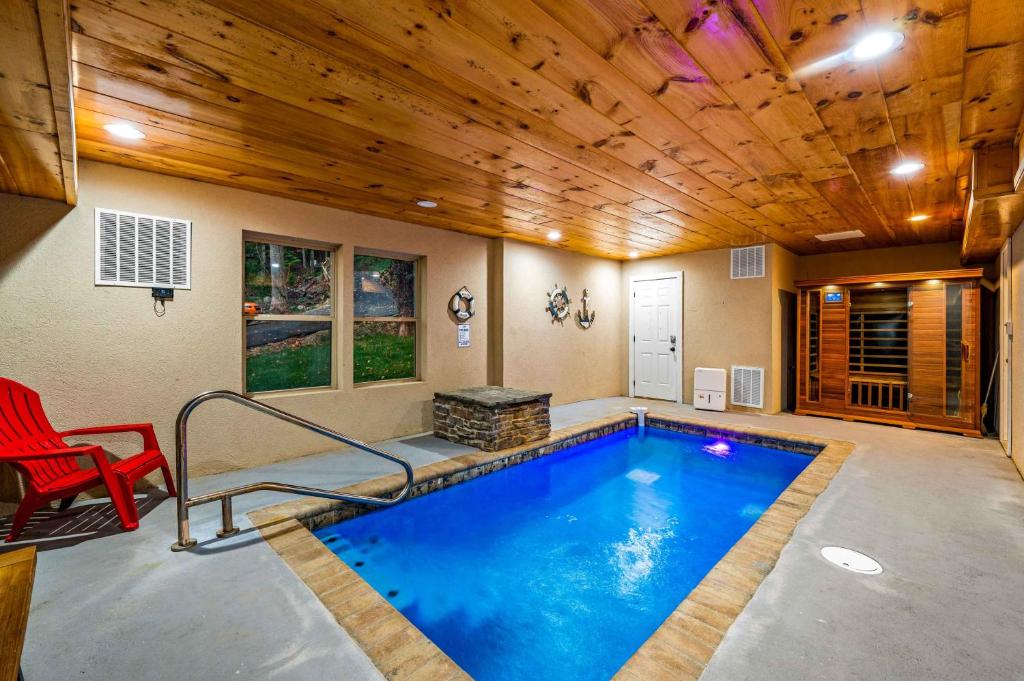 a swimming pool in a house with a wooden ceiling at Heavenly Heights by Ghosal Luxury Lodging in Sevierville