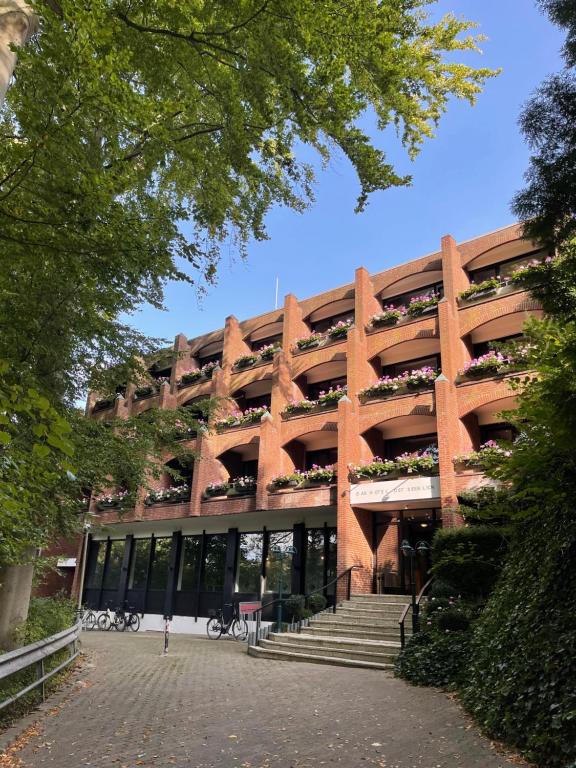 a large building with stairs in front of it at Das Hotel Ostseeblick in Lütjenburg