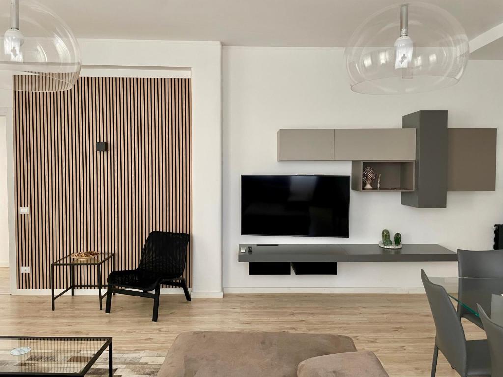 a living room with a flat screen tv on a wall at Aci Boutique Apartment in Acitrezza
