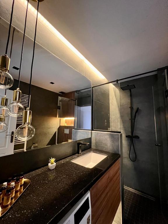 a kitchen with a sink and a counter top at Ghinda Nest in Bistriţa