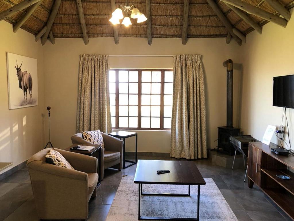 a living room with a couch and a table at Windmill Farm in Bergville