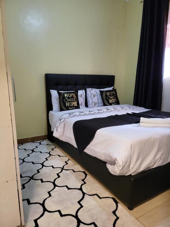 Postel nebo postele na pokoji v ubytování G&G Homes Eldoret