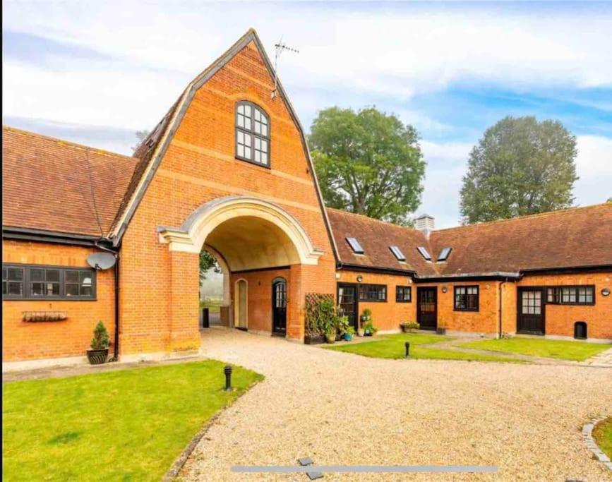 a large brick building with a large archway at 18th Century Converted Coach House 