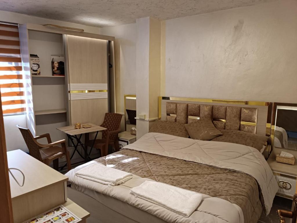 a bedroom with a large bed and a table and chairs at hostel ـ Karak dream in Kerak