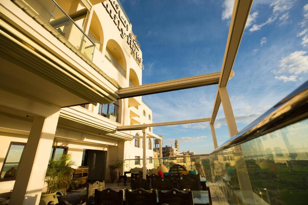 a view from the balcony of a building with chairs at Holy Family Hotel in Jabal aţ Ţayr