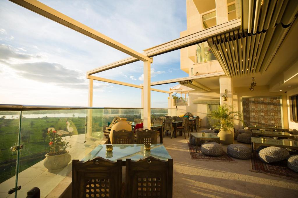 a patio with a table and chairs on a balcony at Holy Family Hotel in Jabal aţ Ţayr