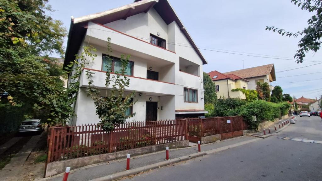 a white house on the side of a street at Flava Hostel in Cluj-Napoca