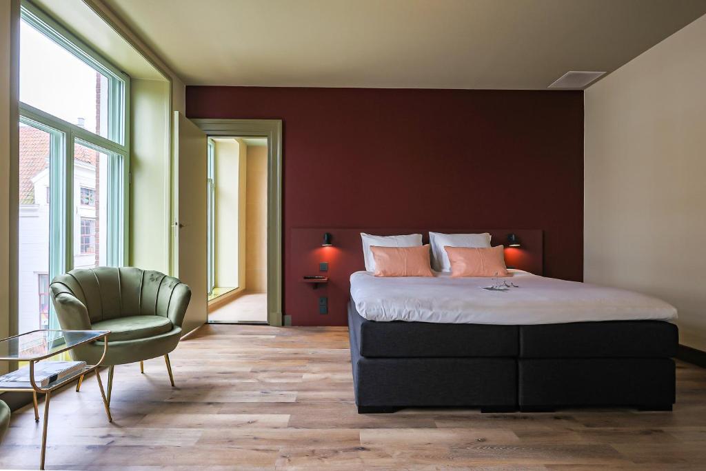 Postel nebo postele na pokoji v ubytování Hotel Corps de Garde