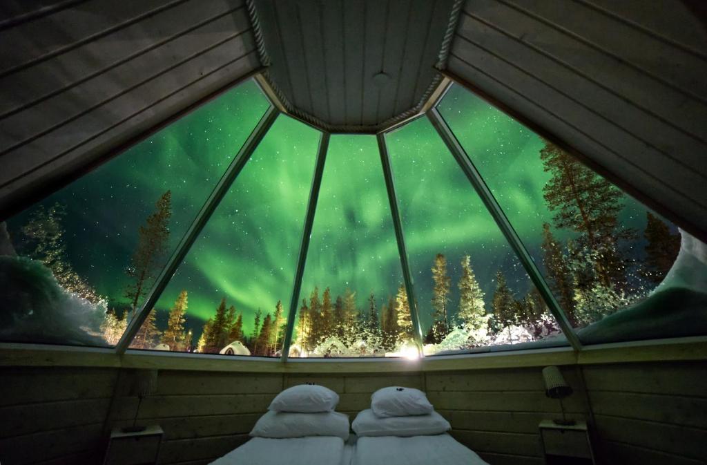 a glass igloo with a view of the northern lights at Northern Lights Village Pyhä in Pyhätunturi