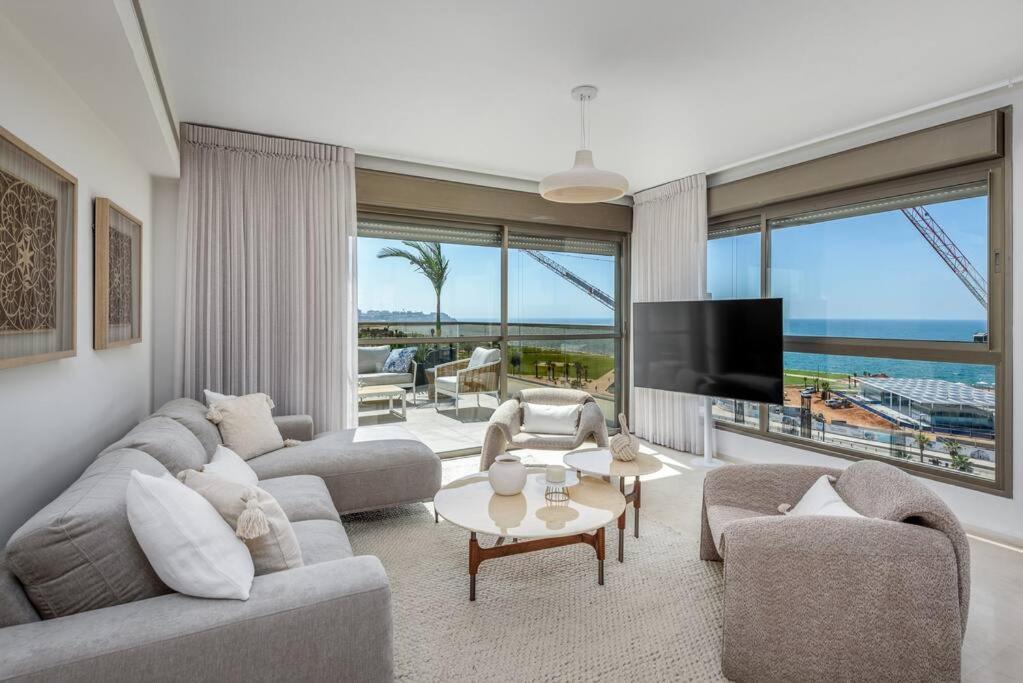 a living room with a couch and a tv at #Breathtaking 4BR/3BA Duplex Seafront in Tel Aviv